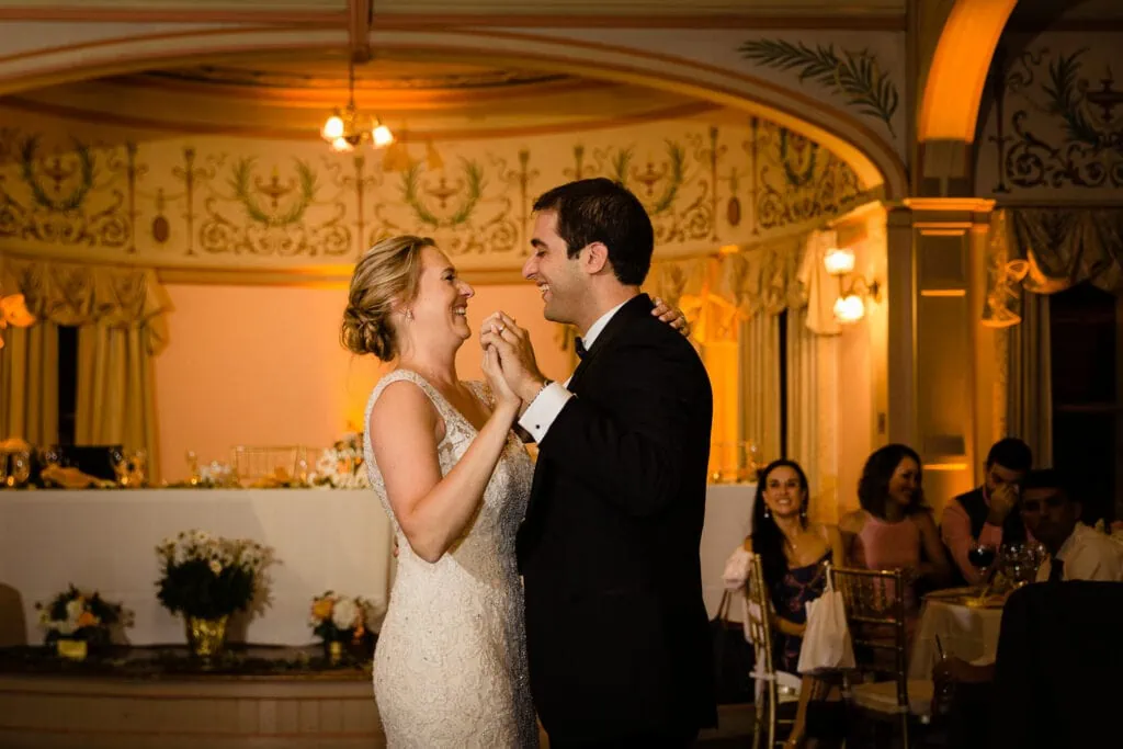 A bride and groom share their first dance in the ballroom at the roger williams casino