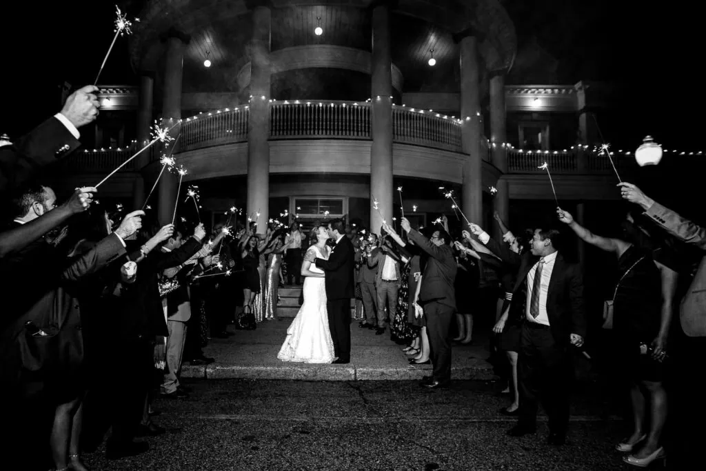 A sparkler sendoff for a bride and groom after their wedding reception at the Roger Williams park casino