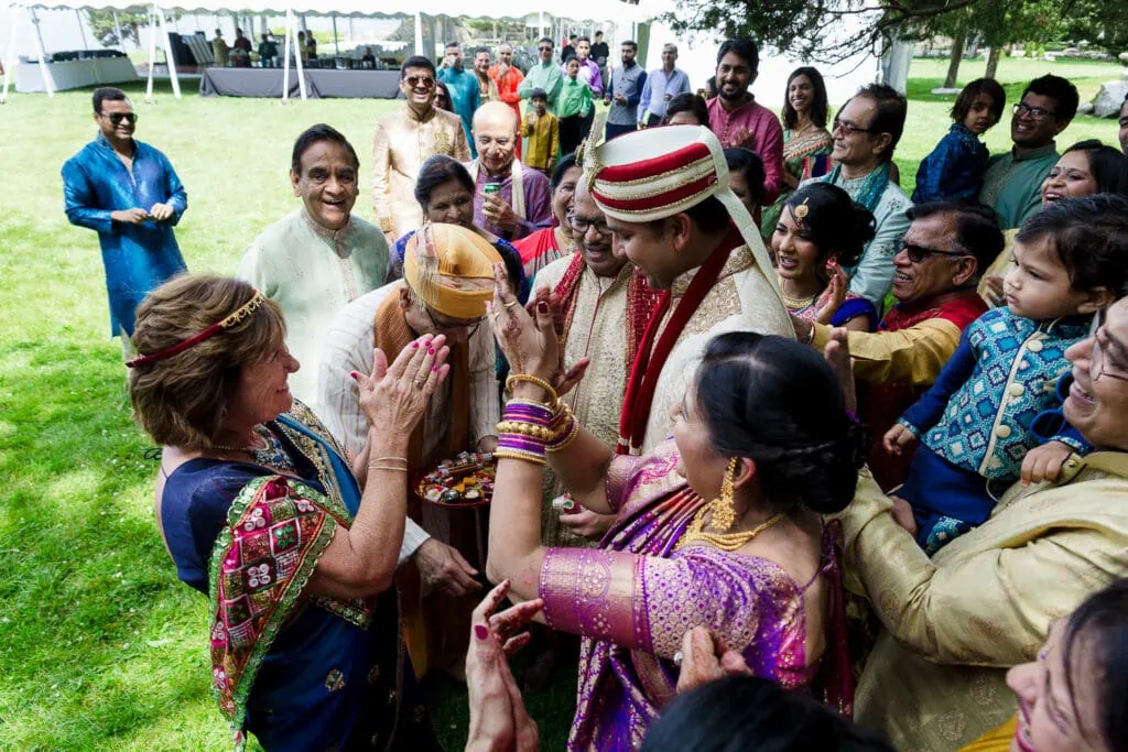 Family meets the groom at the beginning of an indian fusion wedding