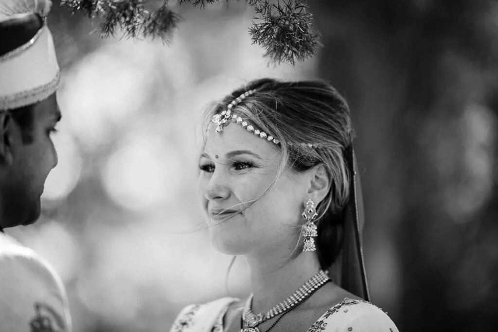 A bride smiles and looks at her groom