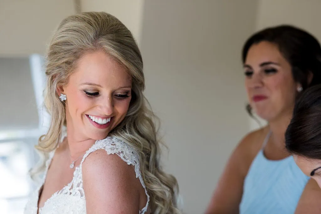 A bride looks back over her shoulder smiling