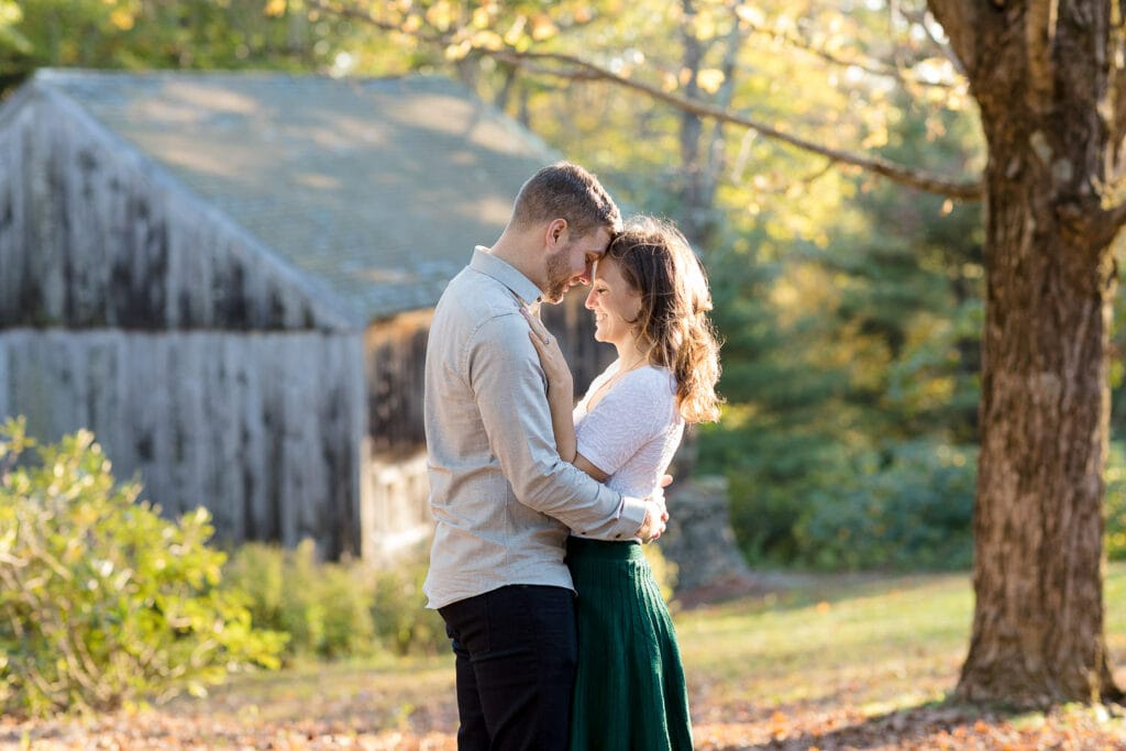A man and woman face each other and touch foreheads at their central ma engagement photography session