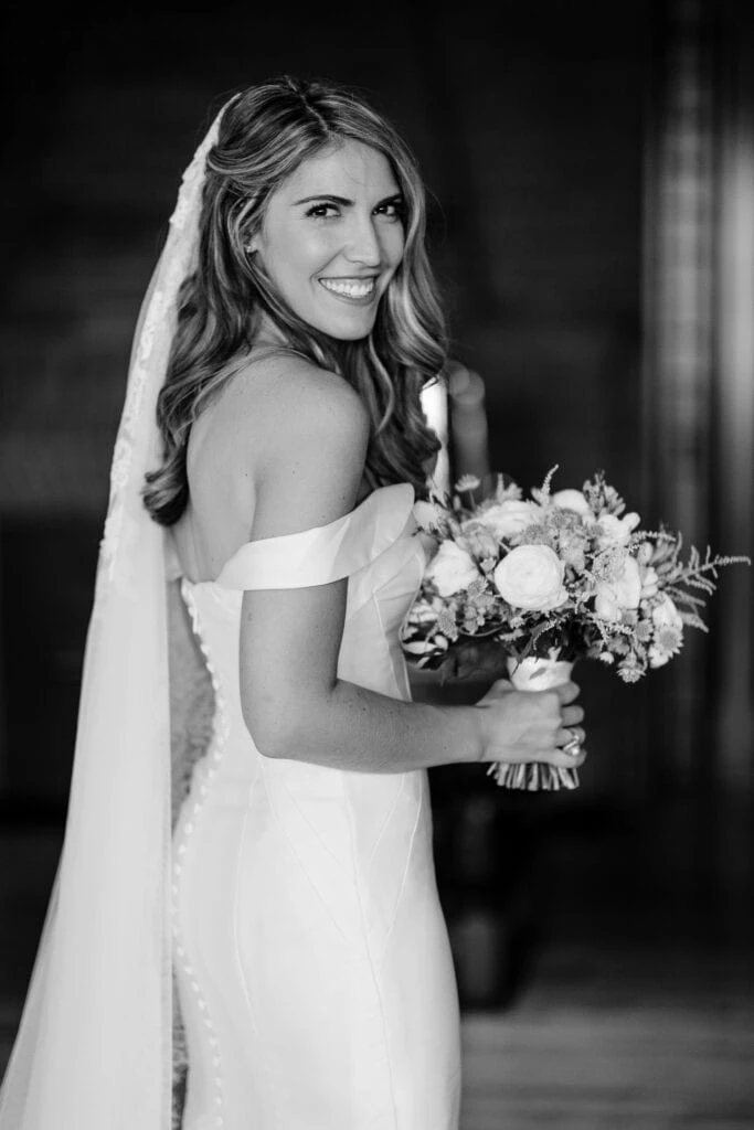 A bride looking back over her shoulder smiling