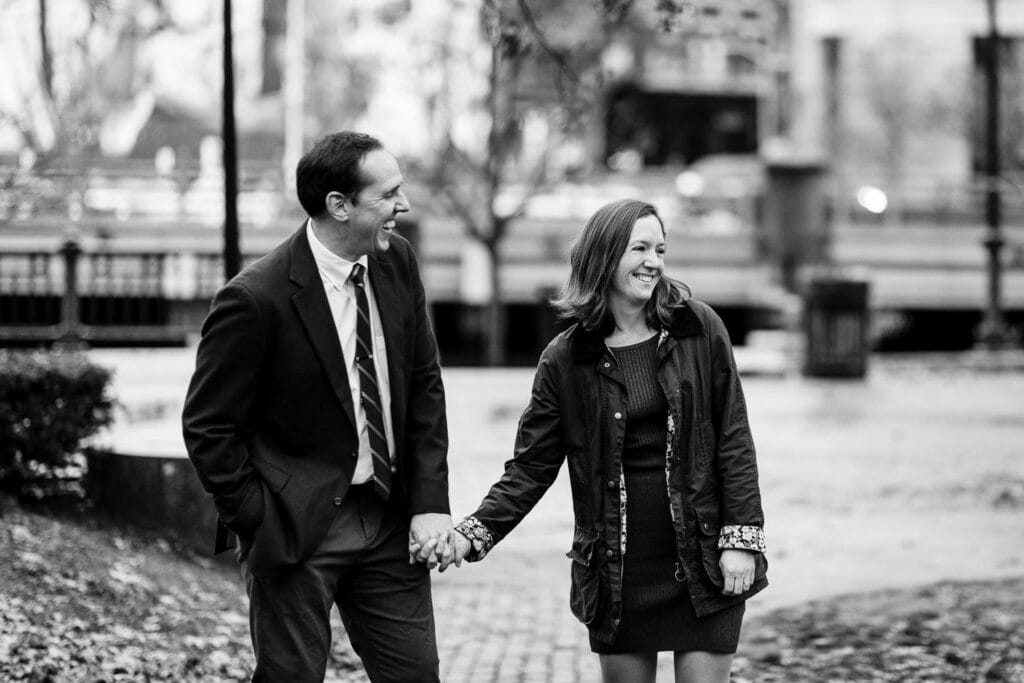 A man and woman laugh during their providence ri engagement session
