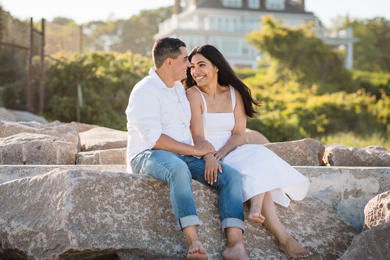 A couple in white at their East Beach Westerly Rhode Island engagement photo session