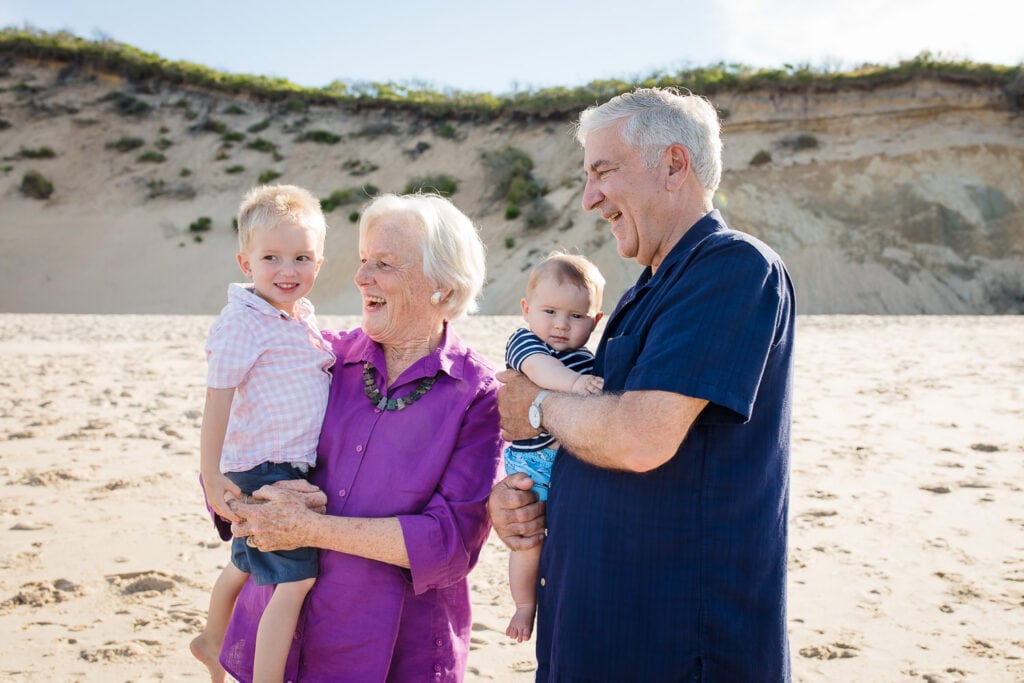 A family in pink and blue during a cape cod family photo session on Newcomb Hollow Beach in Wellfleet Cape Cod