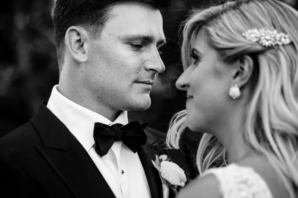 A groom looks intently as his bride
