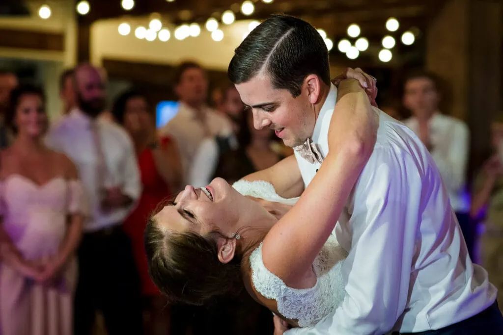 A groom dipping his bride during their first dance at their wedding at the Pickering House in New Hampshire