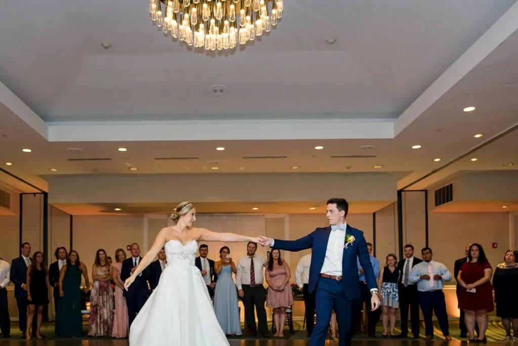 A bride and groom dancing a coreographed dance in the ballroom at the newport marriott