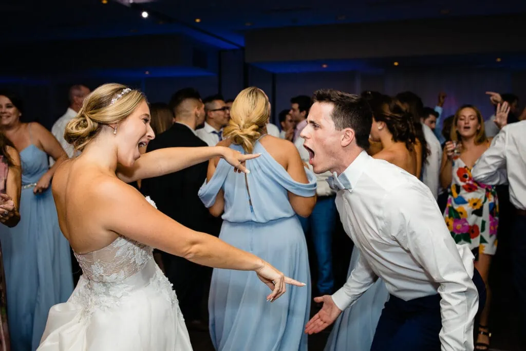 A bride and groom scream singing at each other
