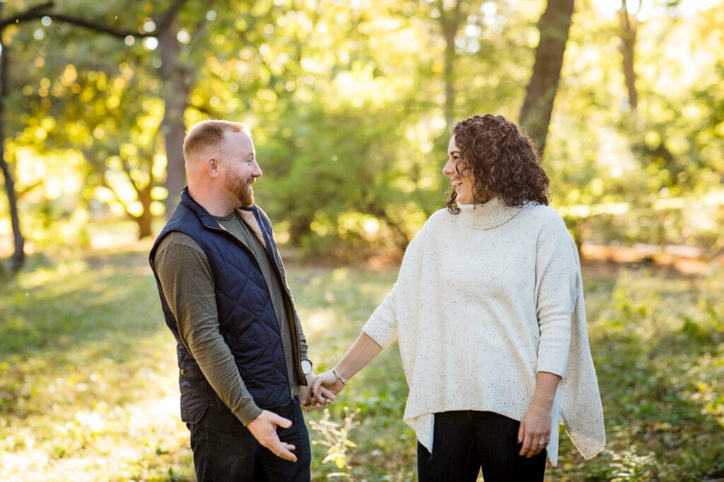 couple laughs for engagement photos at arnold arboretum