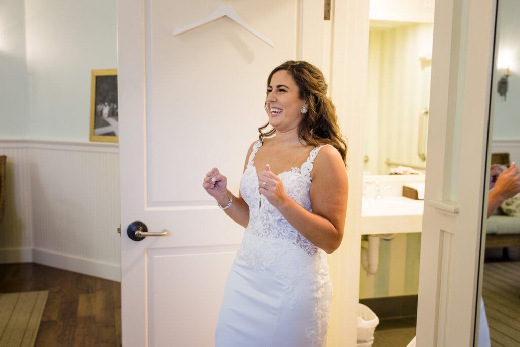 A bride comes out of the bathroom in her wedding gown