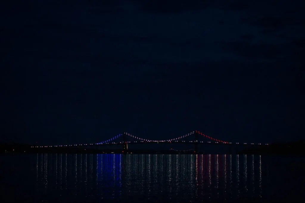The Mount Hope bridge lit up red white and blue for fourth of july as seen at night