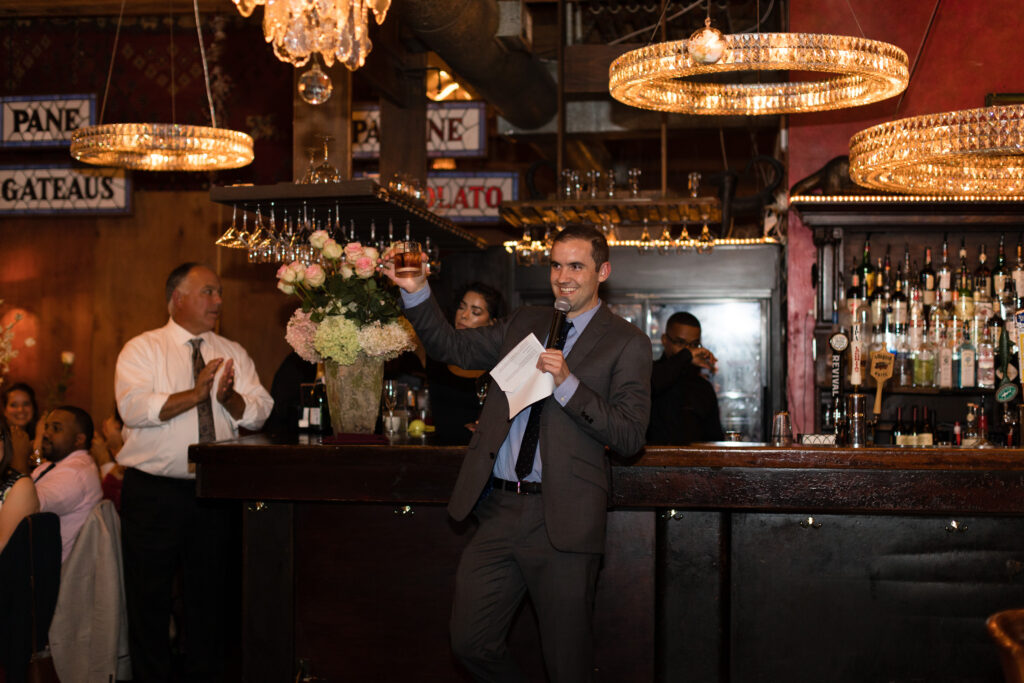 A man toasting at a bar