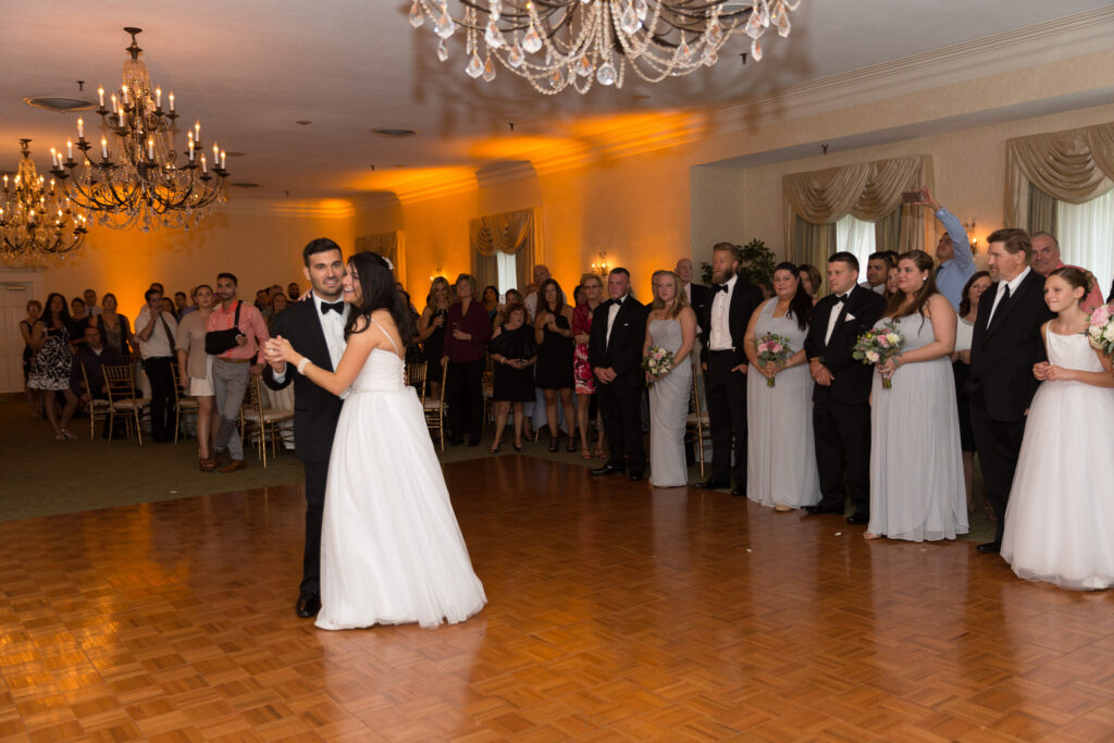 A bride and groom dancing in a banquet hall