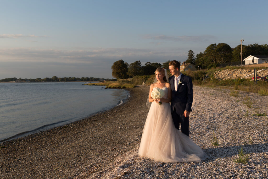 A bride and groom on a rocky beach