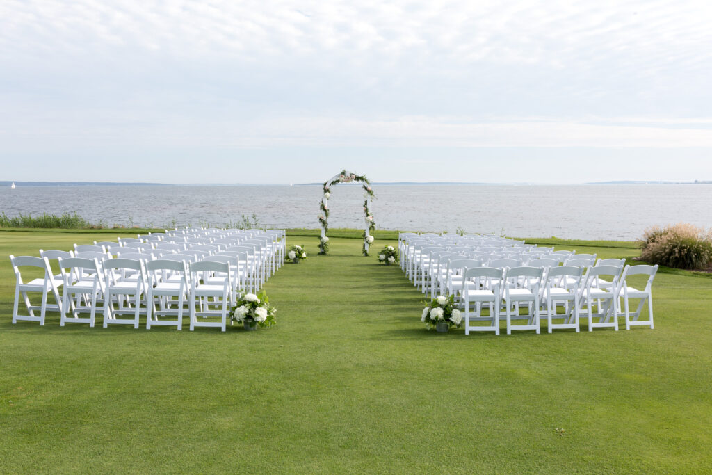 a wedding ceremony setup by the water